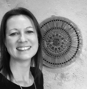 Sarah-Berry-with-mosaic-hanging-on-wall Sarah Berry mosaic artist