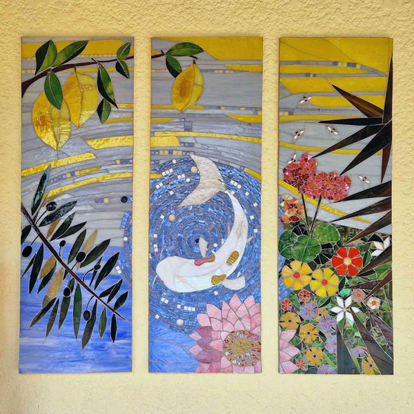 stained glass mosaic triptych hung on a garden wall